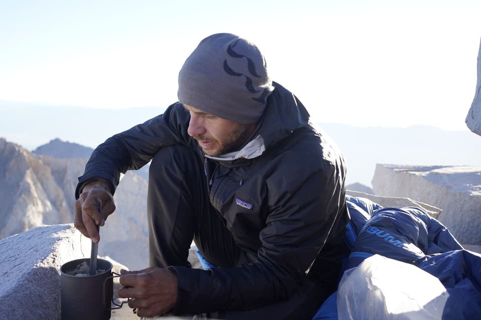 Cooking on a canister stove on the summit rocks