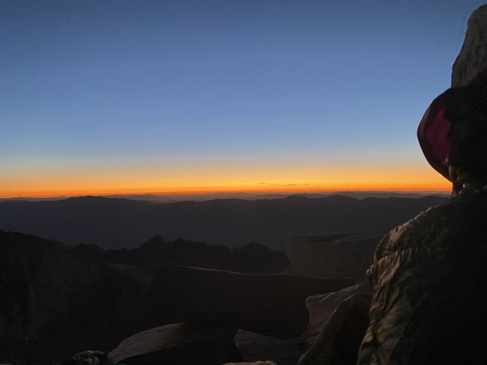 The first band of dawn over Owens Valley from the summit