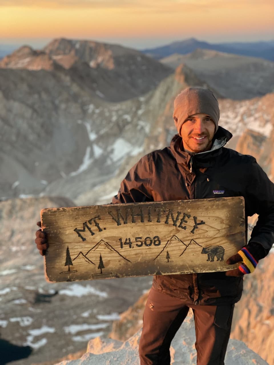 Atlas smiling with the Mt Whitney sign at sunrise