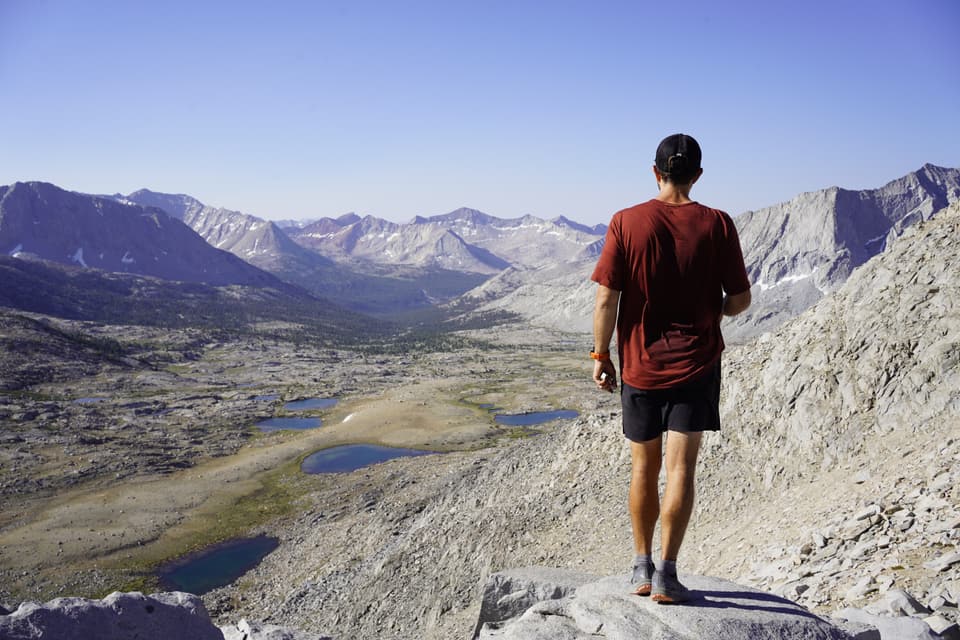 Atlas from behind on a granite point above the Upper Basin lakes on the John Muir Trail, day 51