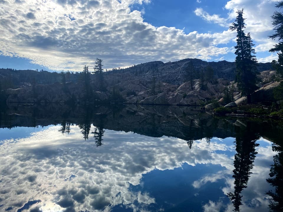 a pond reflecting clouds and granite, day 62 · photo #1543