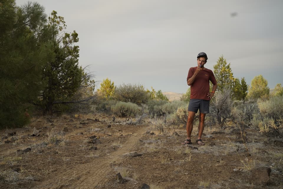 Atlas in a red tee on the Hat Creek Rim at dusk
