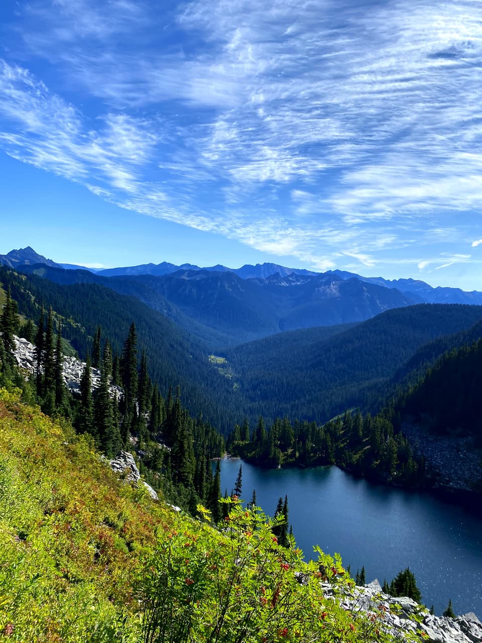 A deep lake below green ridges in the Alpine Lakes country