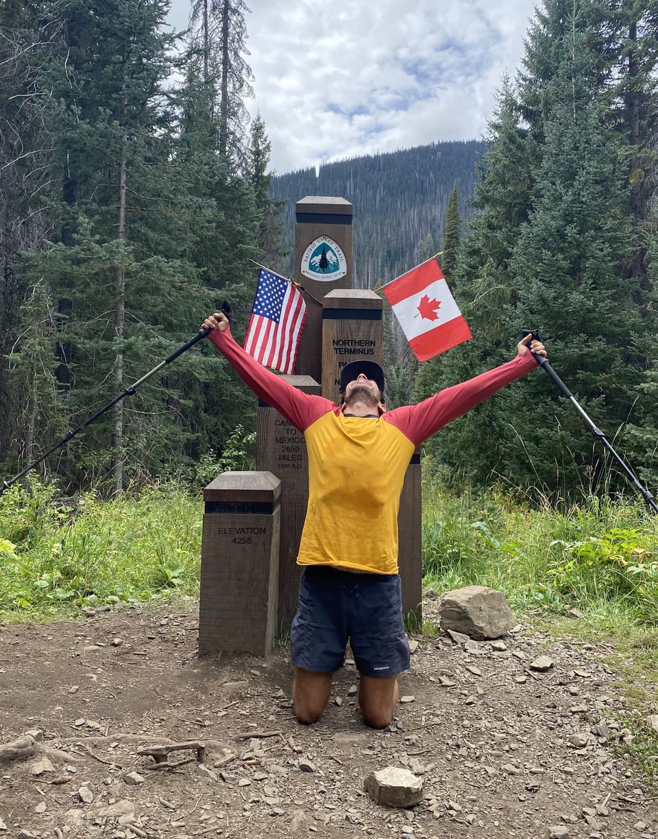 Atlas kneeling with his arms and poles raised at the northern terminus monument, day 129