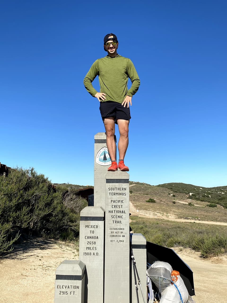 Atlas standing on top of the southern terminus monument at Campo, day 1