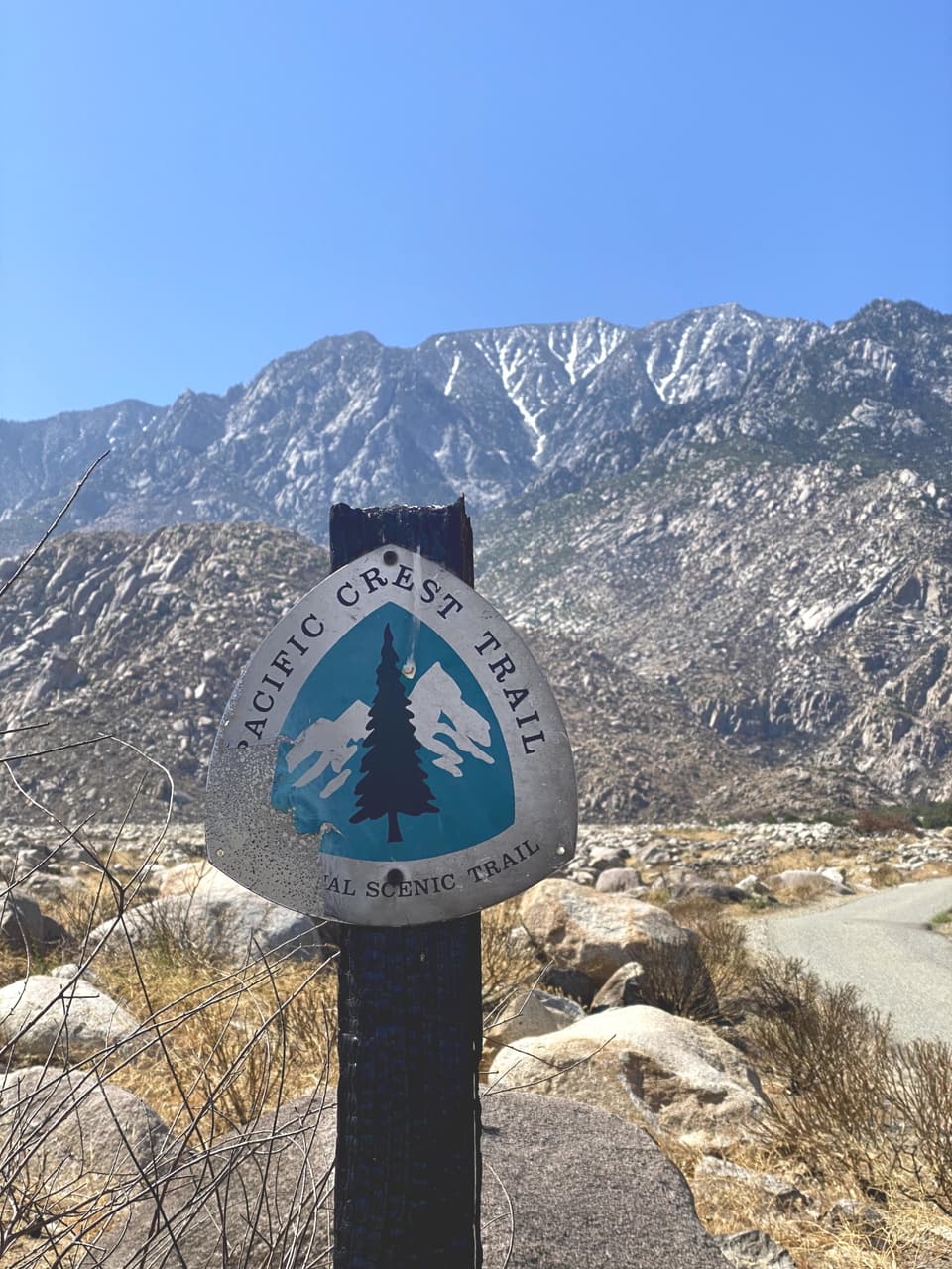 The Pacific Crest Trail emblem on a post with snowy San Jacinto behind, day 15