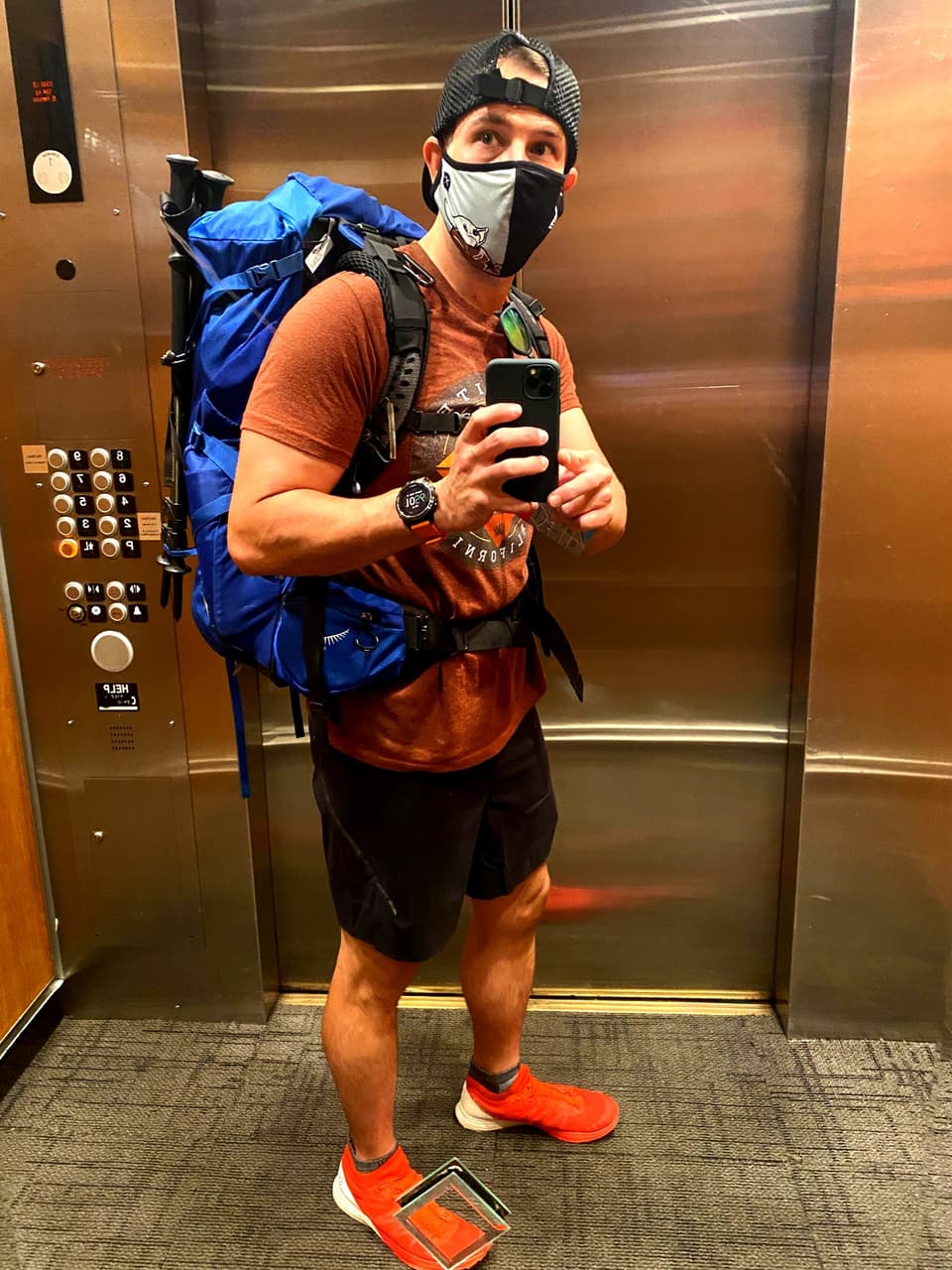 Atlas in a hotel elevator with the big blue Osprey pack before the start
