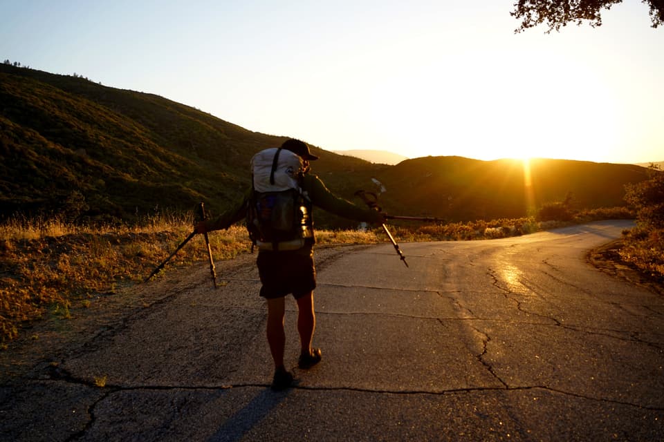 walking the road at sunrise