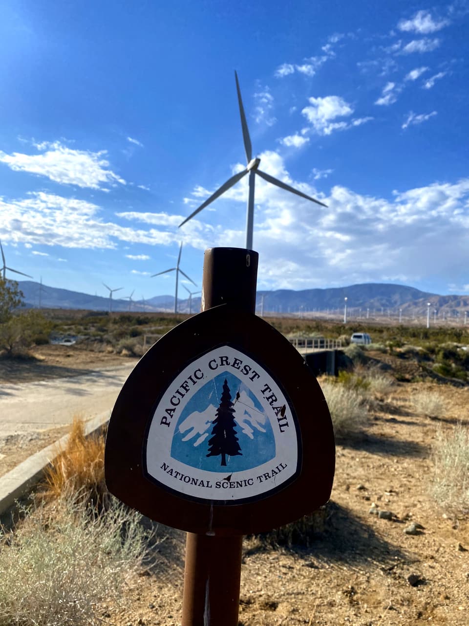 the PCT emblem beneath a wind turbine, day 31