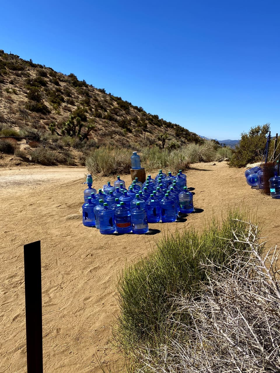 a pallet of water jugs at a cache, day 36
